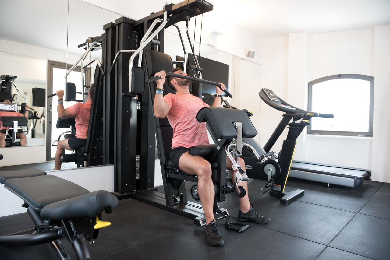 Gasometer Urban Suites Rome Exterior photo A man using a lat pulldown machine